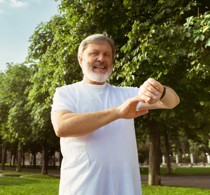 Energetic man outdoors checking his watch